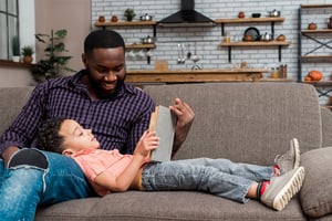 e-edit-black-father-son-reading-book-couch